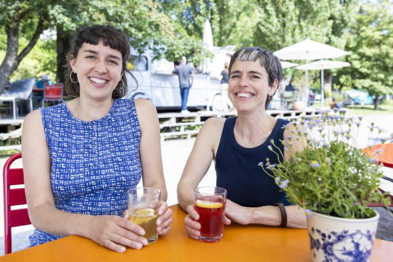 Portrait von Mirjam Zimmermann links und Jael Schüle vor dem Food-Truck am Rhein